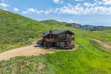 Front  view of property featuring a deck with moun