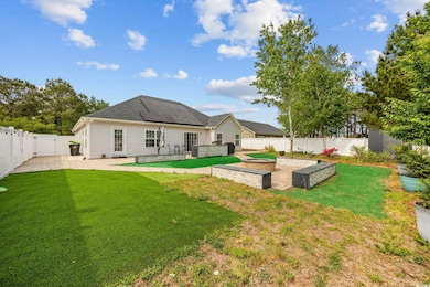 Back of house featuring a patio area, a fenced bac