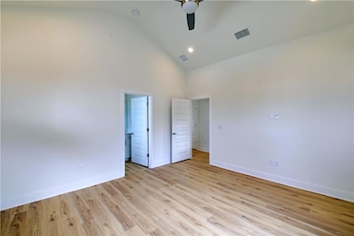 Unfurnished bedroom with visible vents, baseboard