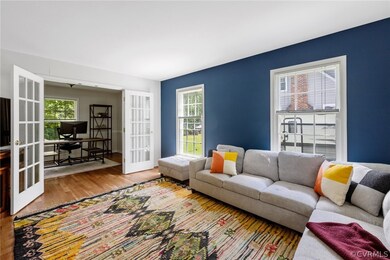 Living room with wood-type flooring and french doors