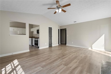 Unfurnished living room with baseboards, a texture