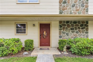 Property entrance with stone siding and a porch