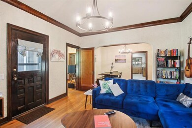 Living room with a chandelier, ornamental molding,