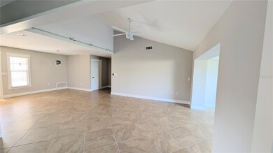 Spacious Living room/Dining room with vaulted ceilings.