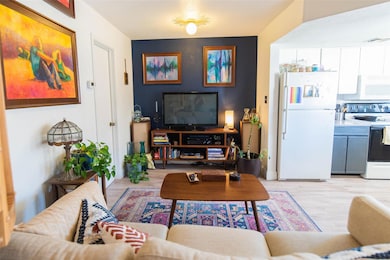 Living room featuring light wood-style flooring a