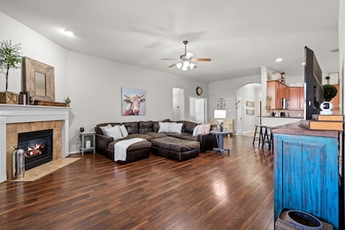 Step into comfort! This expansive living room boasts beautiful laminate flooring, a welcoming fireplace, and an open design, creating a perfect hub for family life and entertaining.