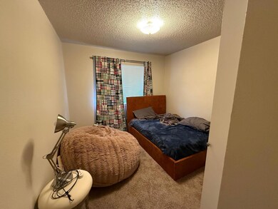 Bedroom with carpet floors and a textured ceiling