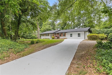 Ranch-style home with concrete driveway