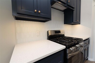 Kitchen featuring decorative backsplash, gas stove