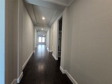 Hall featuring dark wood-style floors and recessed lighting