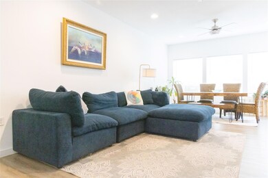 Living area with light wood-style flooring, reces