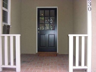 FRONT DOOR ENTRY WITH STEPS LEADING TO SMALL PORCH