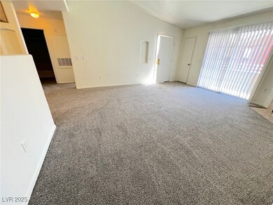 Spare room with carpet floors, vaulted ceiling, an