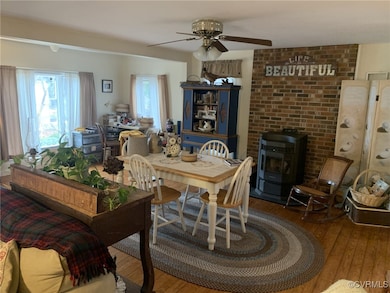 Dining area featuring ceiling fan, wood finished f
