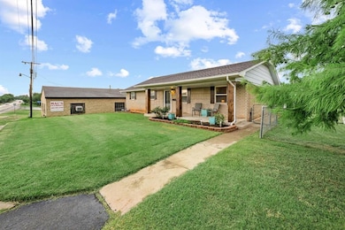 Ranch-style house with brick siding and a porch