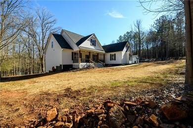 View of front of home featuring covered porch and a front yard