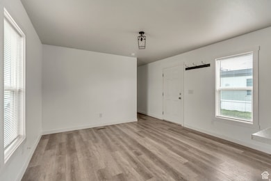 Foyer entrance with light wood finished floors
