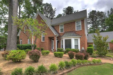 Beuatifully landscaped, treed front lawn.