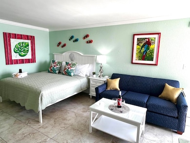 Bedroom featuring crown molding and a textured wall