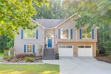 Split foyer home featuring driveway and a garage