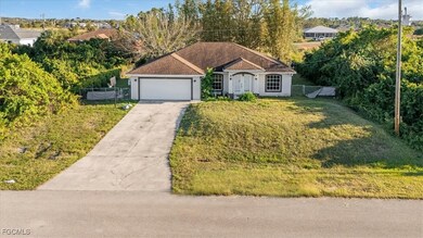 View of front facade with concrete driveway, an attached garage, and stucco siding