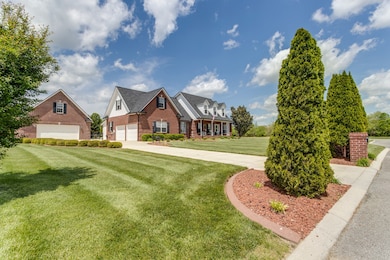 The concrete driveway,  curbed street and custom brick mailbox are additional features.