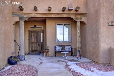 View of exterior entry with a patio area