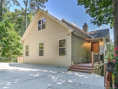 Parking pad for 4 cars and front door, on Laurel Loop
