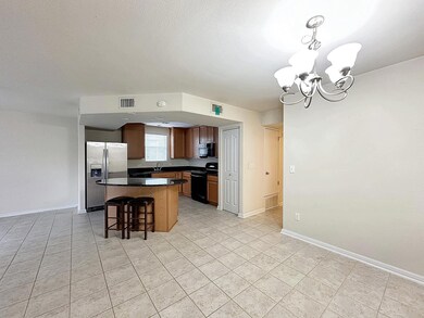 Kitchen with range, black microwave, visible vent