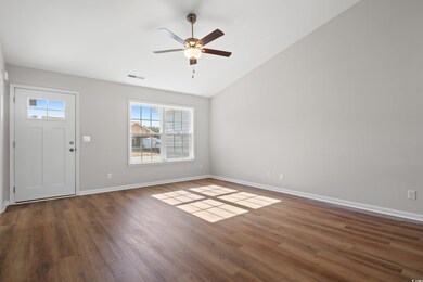 Entryway featuring ceiling fan, lofted ceiling, an