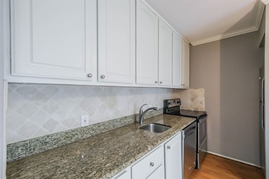 The kitchen has granite counters and tile backsplash.