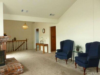 Stairs lead up to dining area that adjoins living 