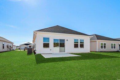 Rear view of property featuring a yard, a patio ar