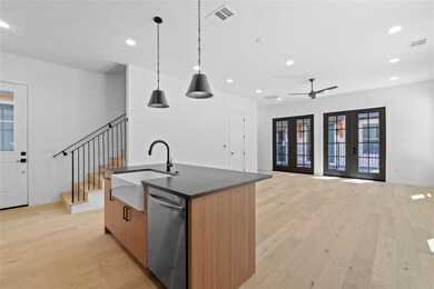 Kitchen featuring visible vents, dishwasher, a si