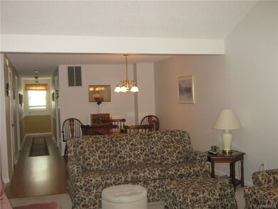 Hallway and dining area have laminate, wood look f