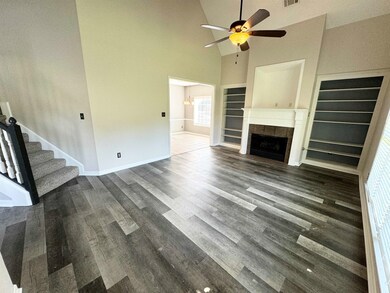 Unfurnished living room with high vaulted ceiling,