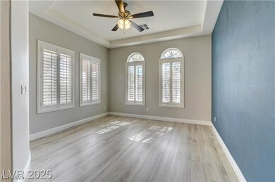 Spare room featuring a raised ceiling, wood finish