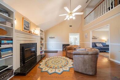 Living room featuring a high end fireplace, hardwo