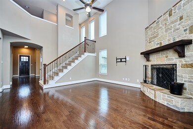 Spacious living room featuring an open floor plan with vaulted ceilings and beautiful hard wood floors