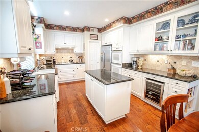 Beautiful kitchen featuring granite counters, island and open layout.