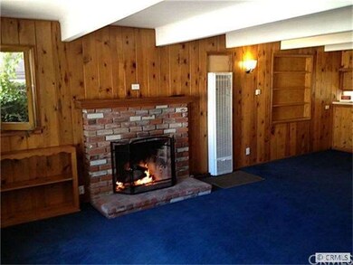 Spacious Living Rm with Brick Fireplace off Dining