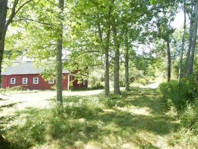Barn and roadway leading up into...