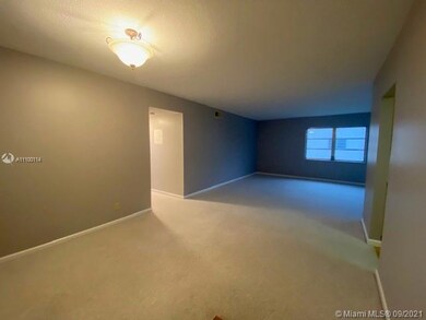 Entering condo unit viewing dining and living area