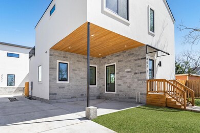 Rear view of house with a yard, stone siding, a p