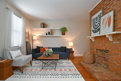 The warm and welcoming living room features a floo