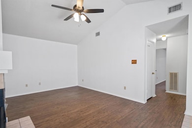 Unfurnished living room featuring a ceiling fan, 