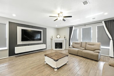 Anchored by a sleek fireplace and modern slatted a