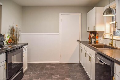 Remodeled kitchen with new white cabinets.