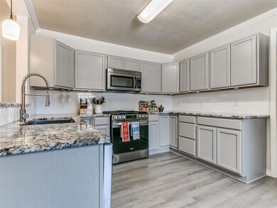 Kitchen featuring light granite countertops, gray 