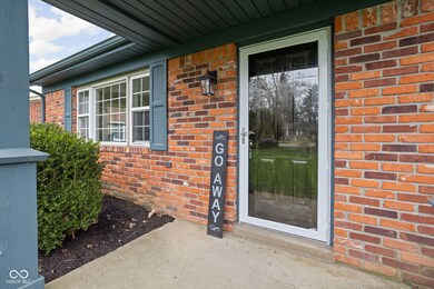 view of exterior entry featuring brick siding